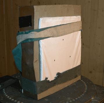 Firing pack strapped to block of Plastilina